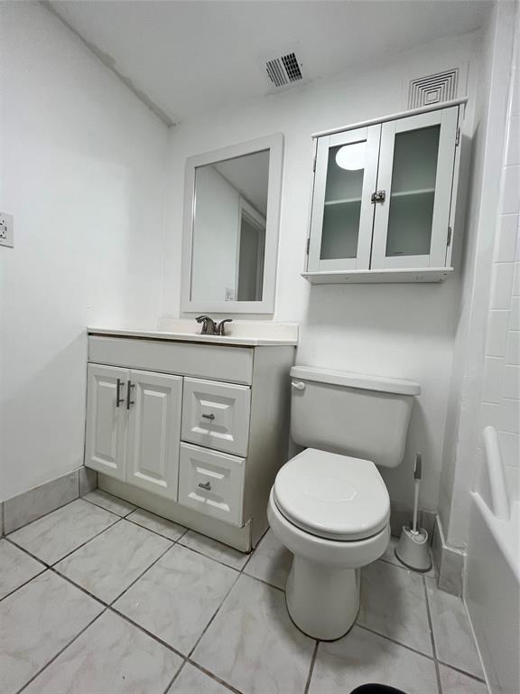 7925 Fairview Drive, Unit 101 Tamarac, FL 33321 - Photo 24 of 48 a bathroom with a toilet sink and mirror