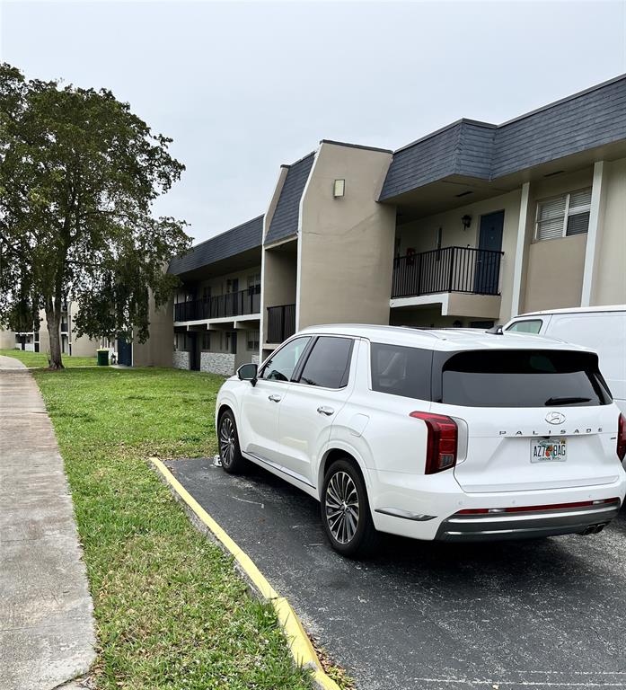 7925 Fairview Drive, Unit 101 Tamarac, FL 33321 - Photo 48 of 48 a car parked in front of white house
