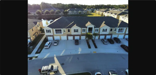 an aerial view of a house with a big yard