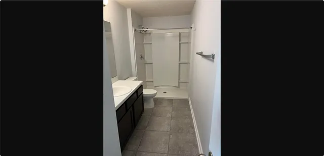 a bathroom with a double vanity sink toilet and shower