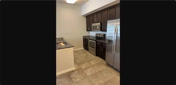 a kitchen with a refrigerator stove and microwave