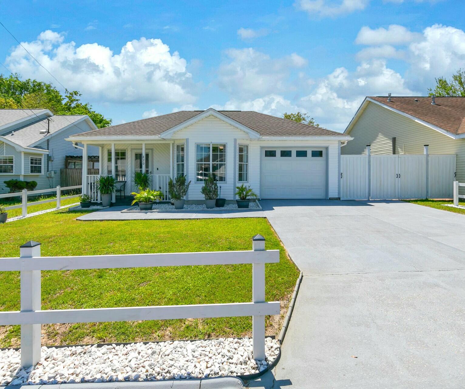 a view of house with swimming pool and yard