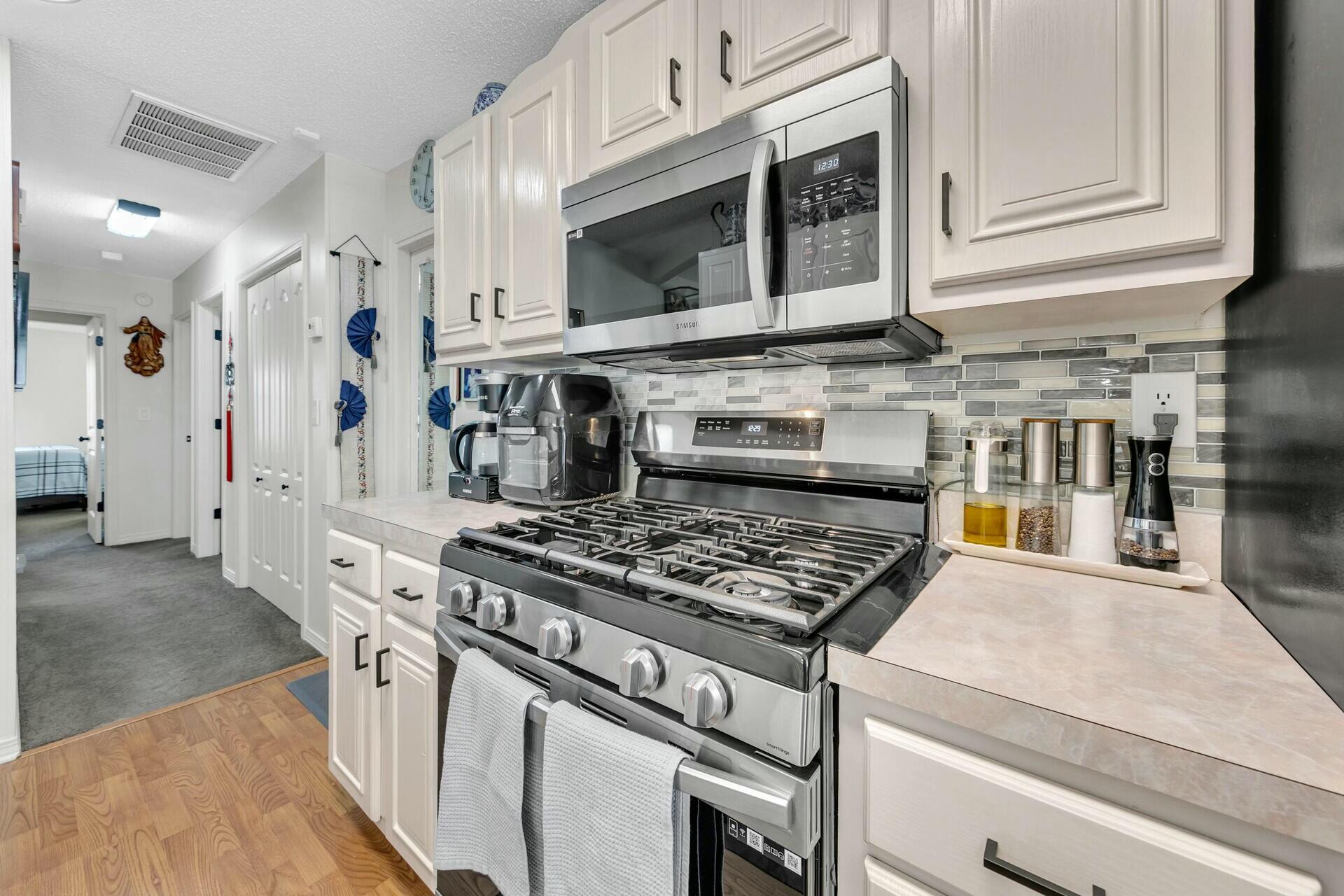 420 Apple Drive Crestview, FL 32536 - Photo 11 of 32 a kitchen with stainless steel appliances granite countertop a stove and a microwave