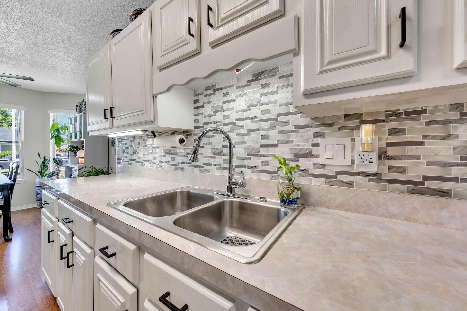 420 Apple Drive Crestview, FL 32536 - Photo 12 of 32 a kitchen with stainless steel appliances and a sink