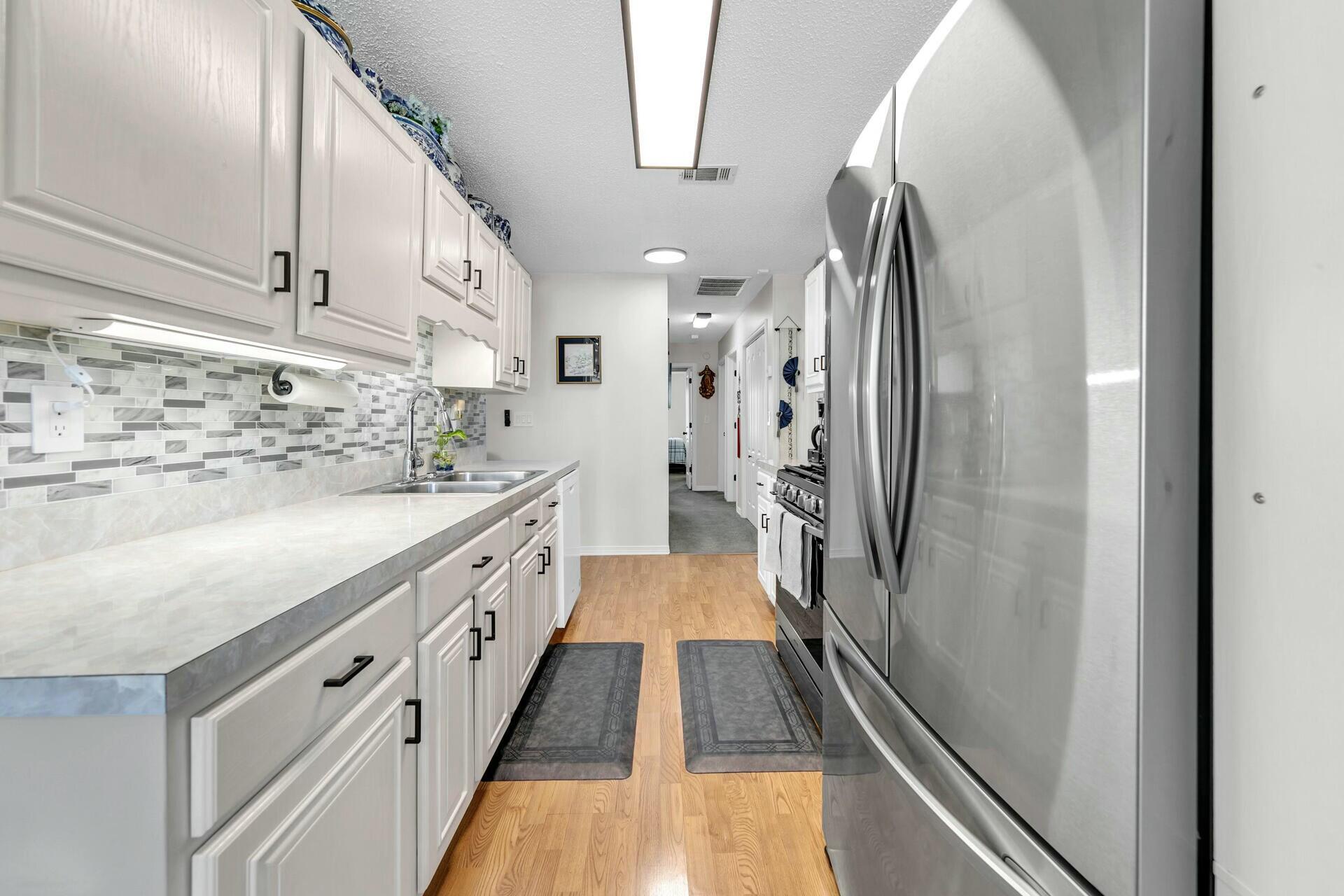420 Apple Drive Crestview, FL 32536 - Photo 13 of 32 a bathroom with a double vanity sink and a mirror