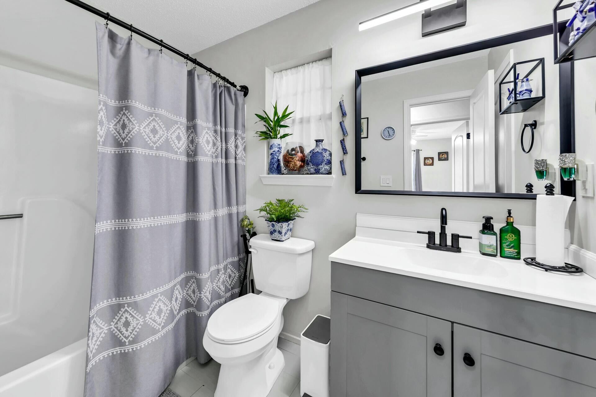 420 Apple Drive Crestview, FL 32536 - Photo 16 of 32 a bathroom with a sink a toilet and a mirror