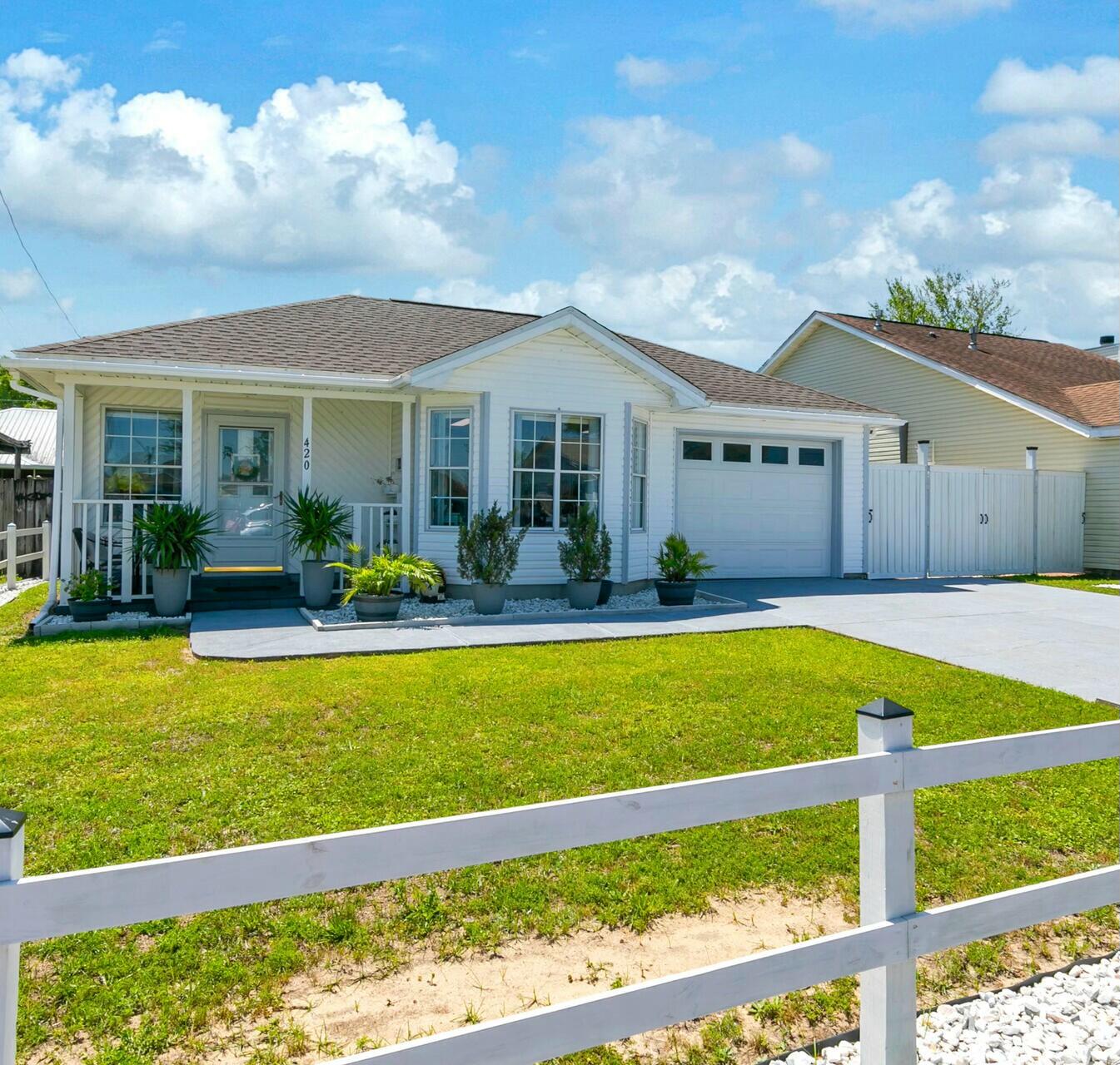 420 Apple Drive Crestview, FL 32536 - Photo 2 of 32 a front view of a house with swimming pool garden and porch