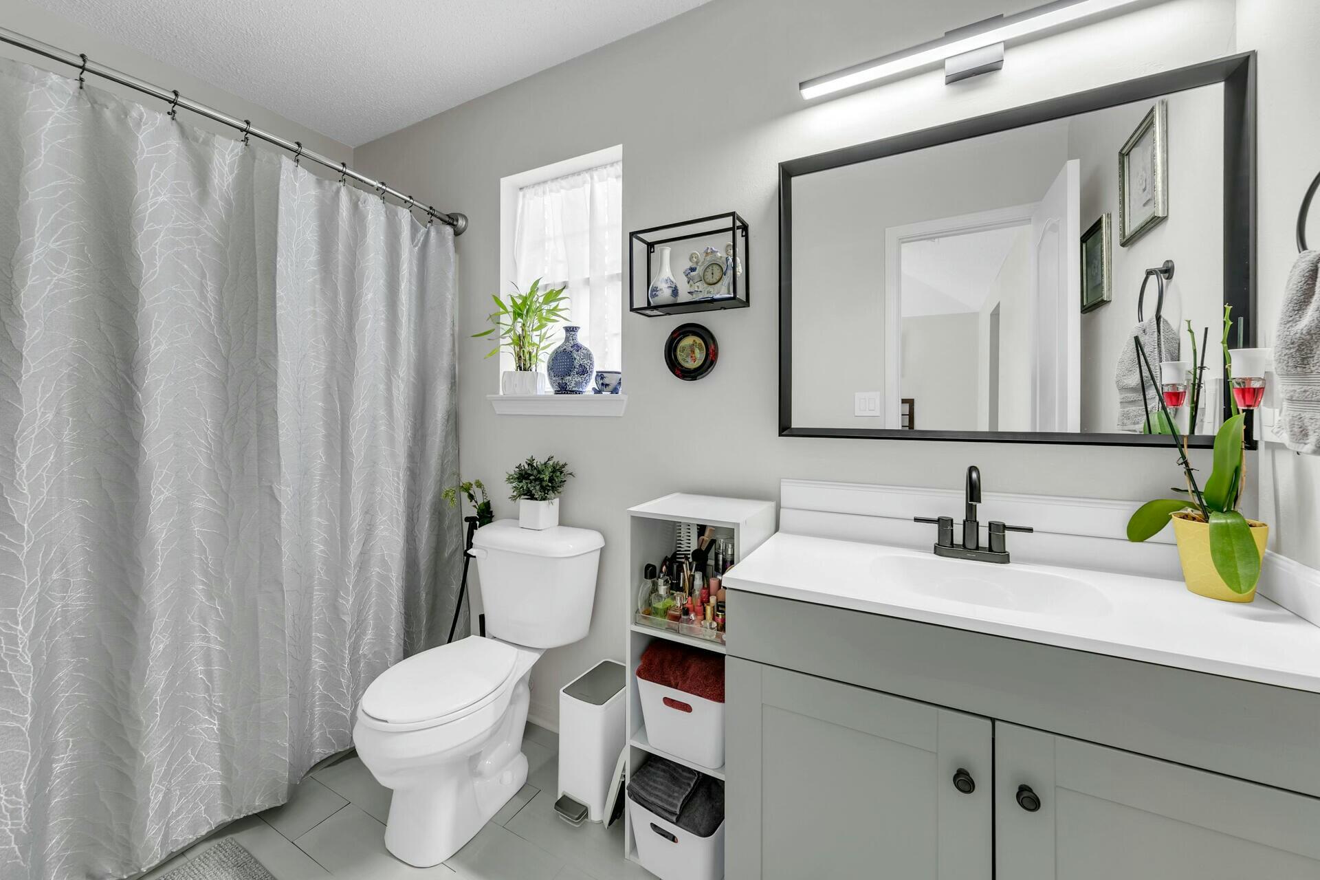420 Apple Drive Crestview, FL 32536 - Photo 21 of 32 a bathroom with a sink a toilet and a mirror