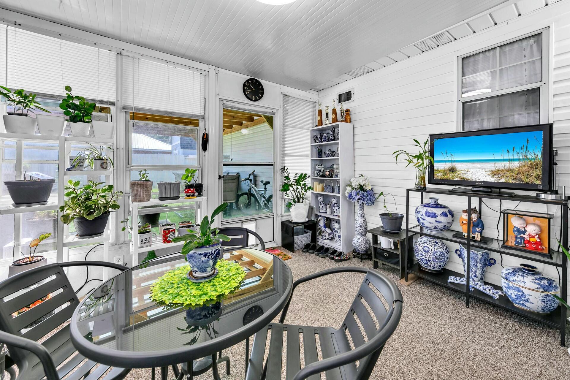 420 Apple Drive Crestview, FL 32536 - Photo 25 of 32 a living room with furniture a flat screen tv and a table
