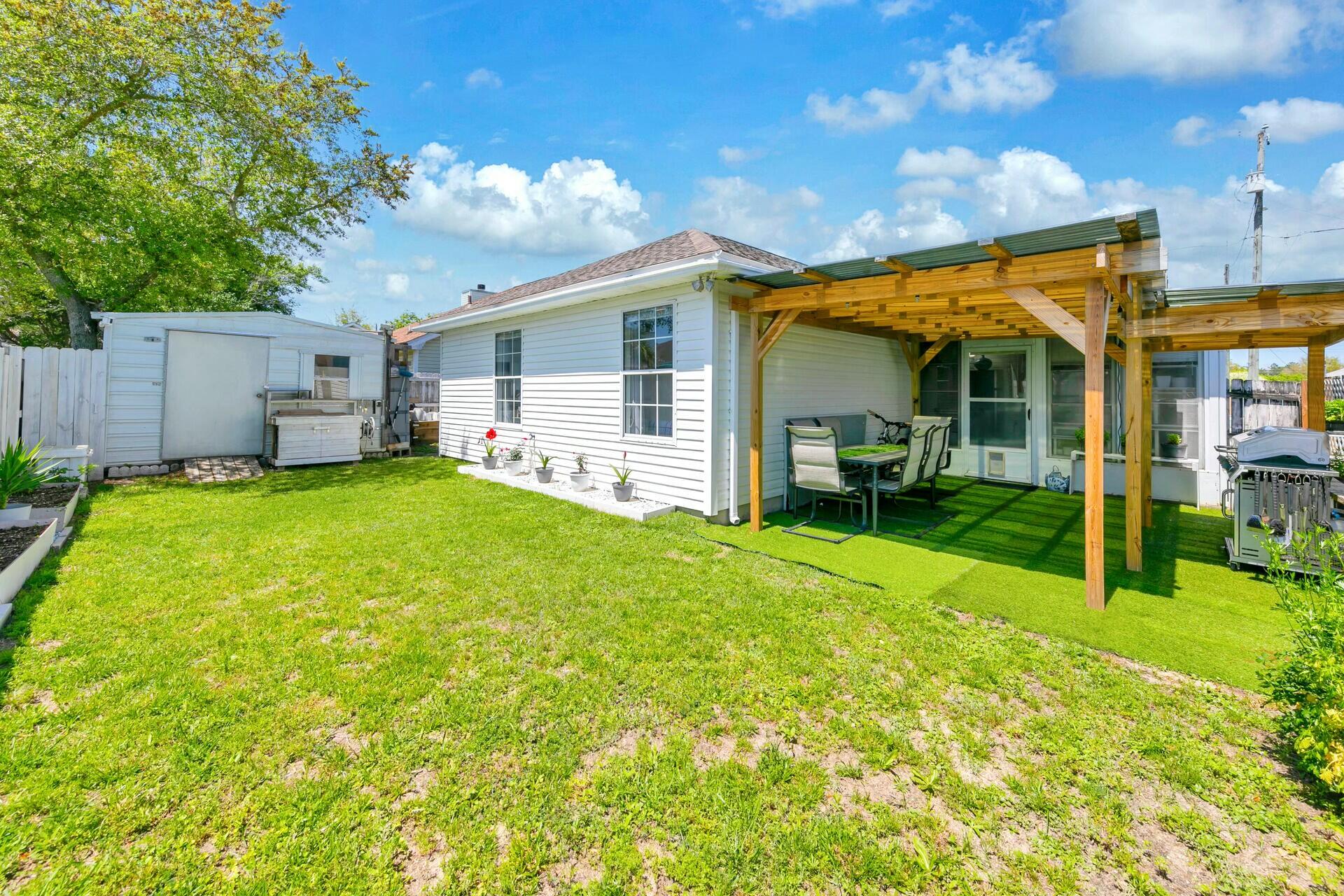 420 Apple Drive Crestview, FL 32536 - Photo 28 of 32 a view of a house with a yard and sitting area