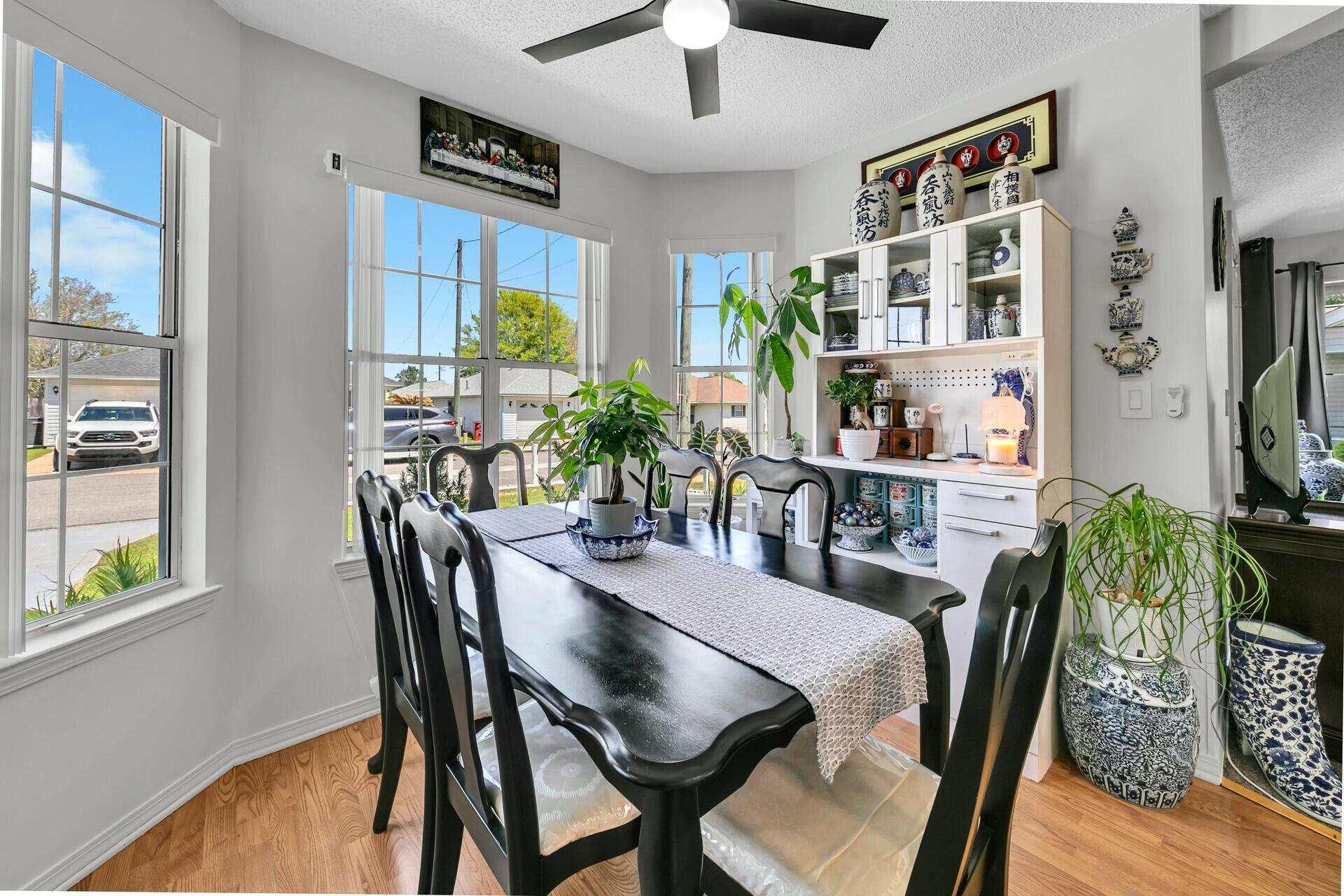 420 Apple Drive Crestview, FL 32536 - Photo 7 of 32 a view of a dining room with furniture window and wooden floor
