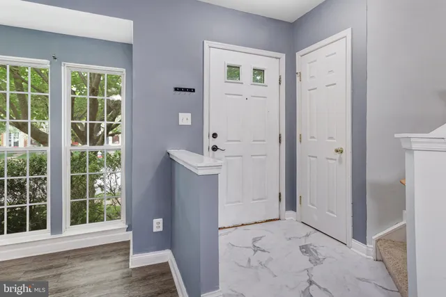an empty room with windows and entrance