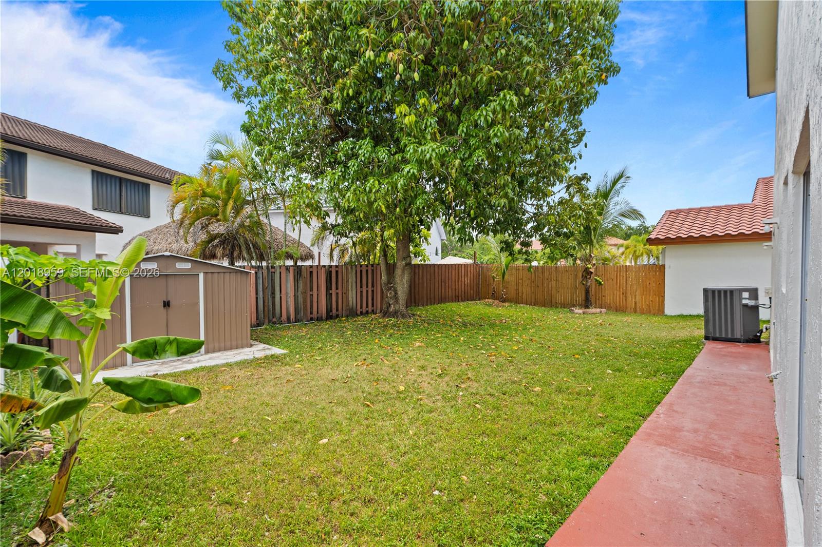 15345 Southwest 63rd Terrace Miami, FL 33193 - Photo 48 of 51 a front view of a house with a yard and a tree