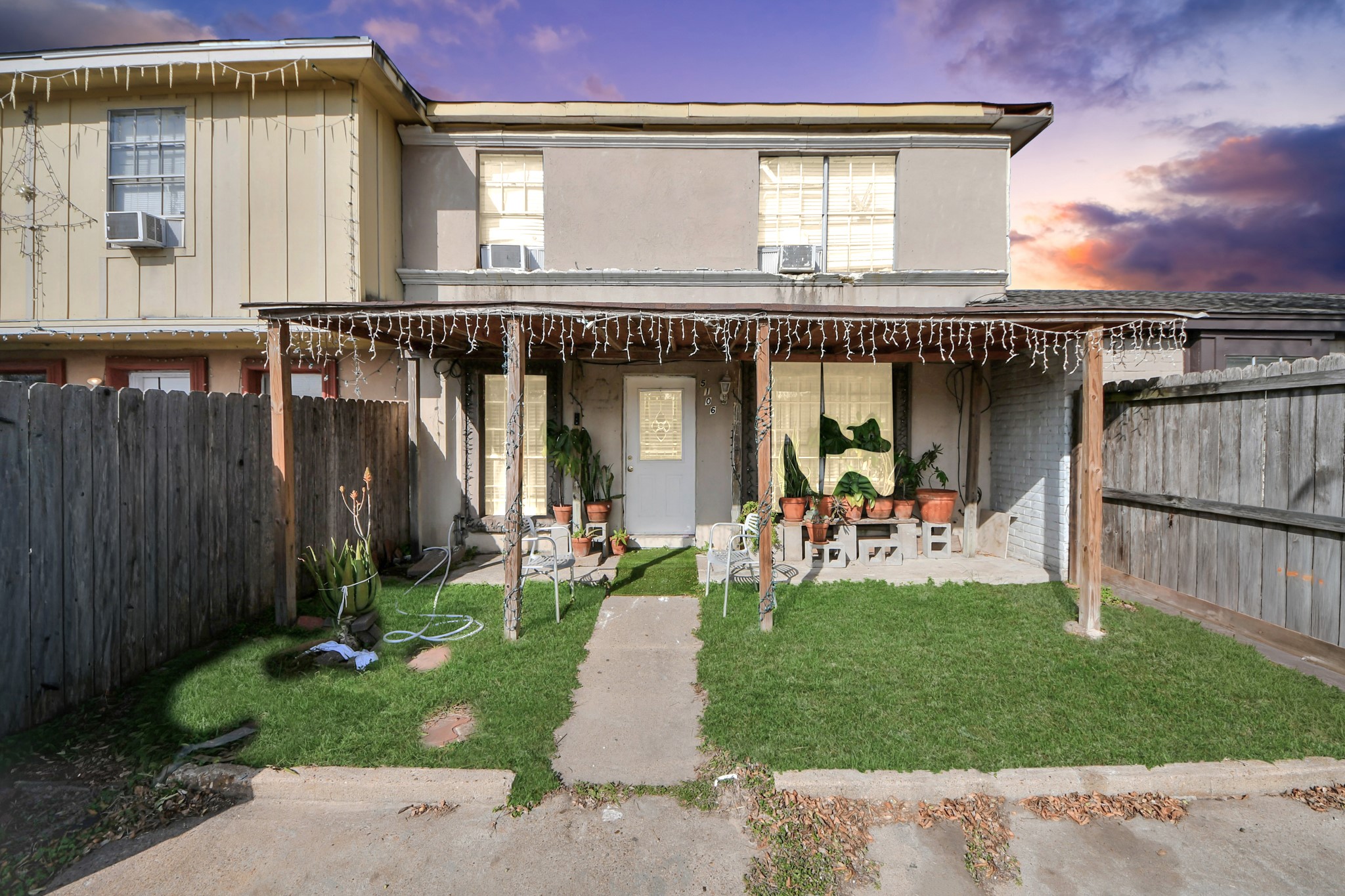 a front view of a house with a garden and plants