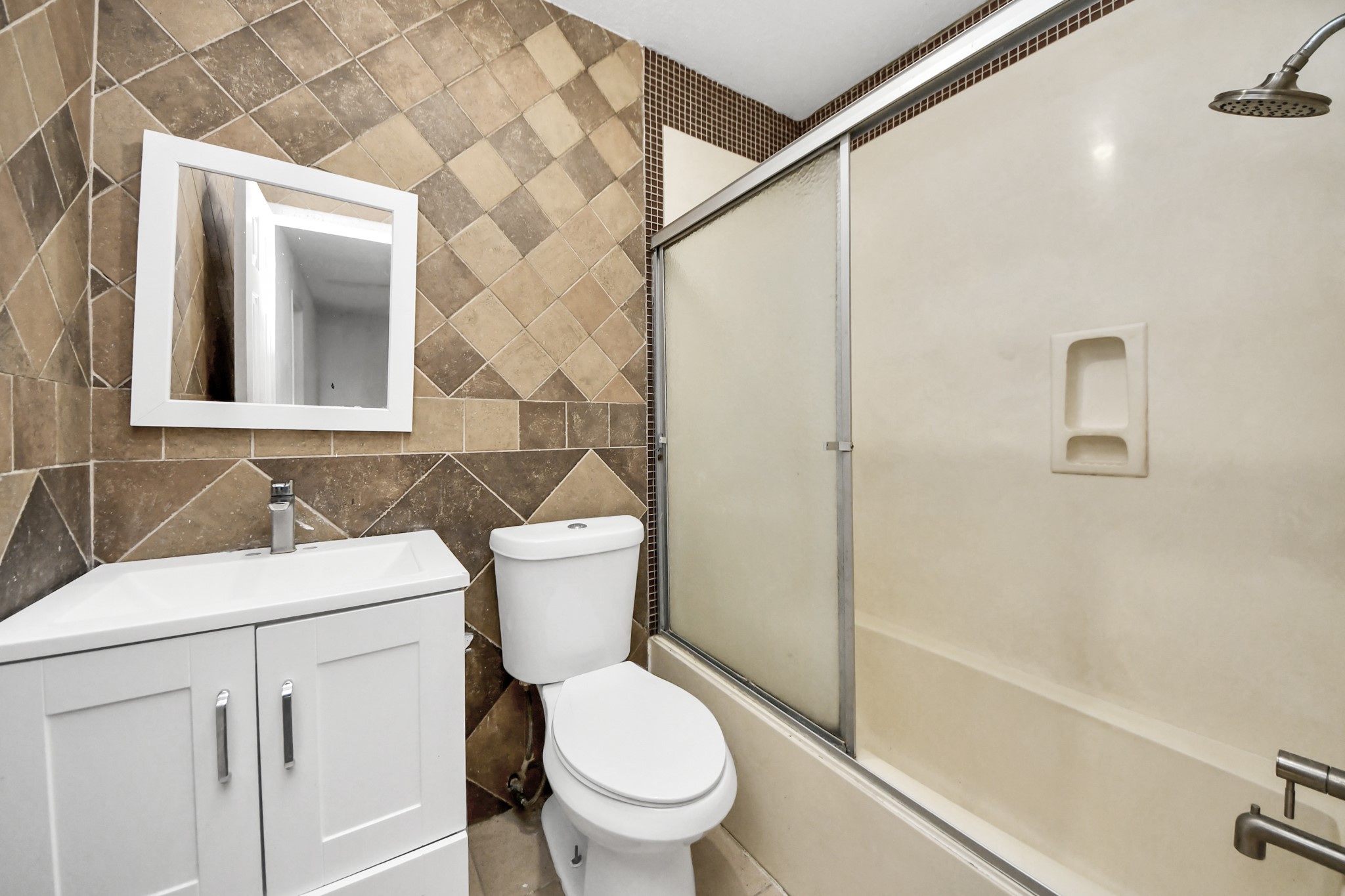 5106 Ingomar Way Houston, TX 77053 - Photo 11 of 14 a bathroom with a toilet sink and shower