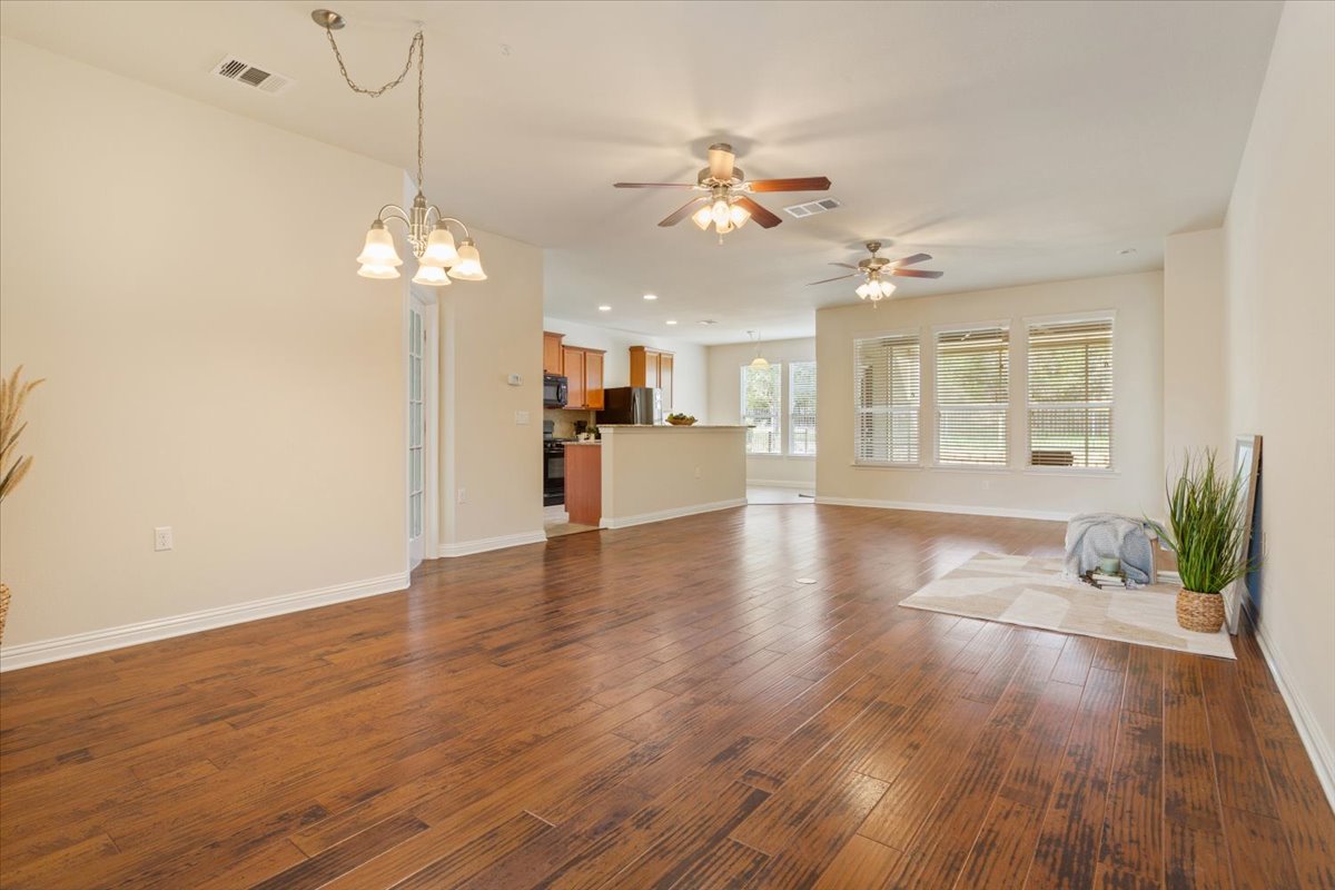 108 Cathedral Mountain Pass Georgetown, TX 78633 - Photo 9 of 36 a view of a room with wooden floor chandelier and windows