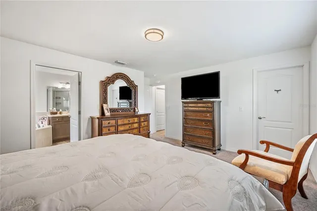 a bathroom with a tub a double vanity sink and a large mirror