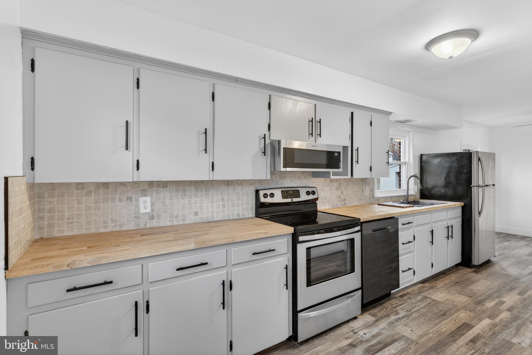 10 Dixie Drive Red Lion, PA 17356 - Photo 11 of 32 a kitchen with white cabinets and white appliances