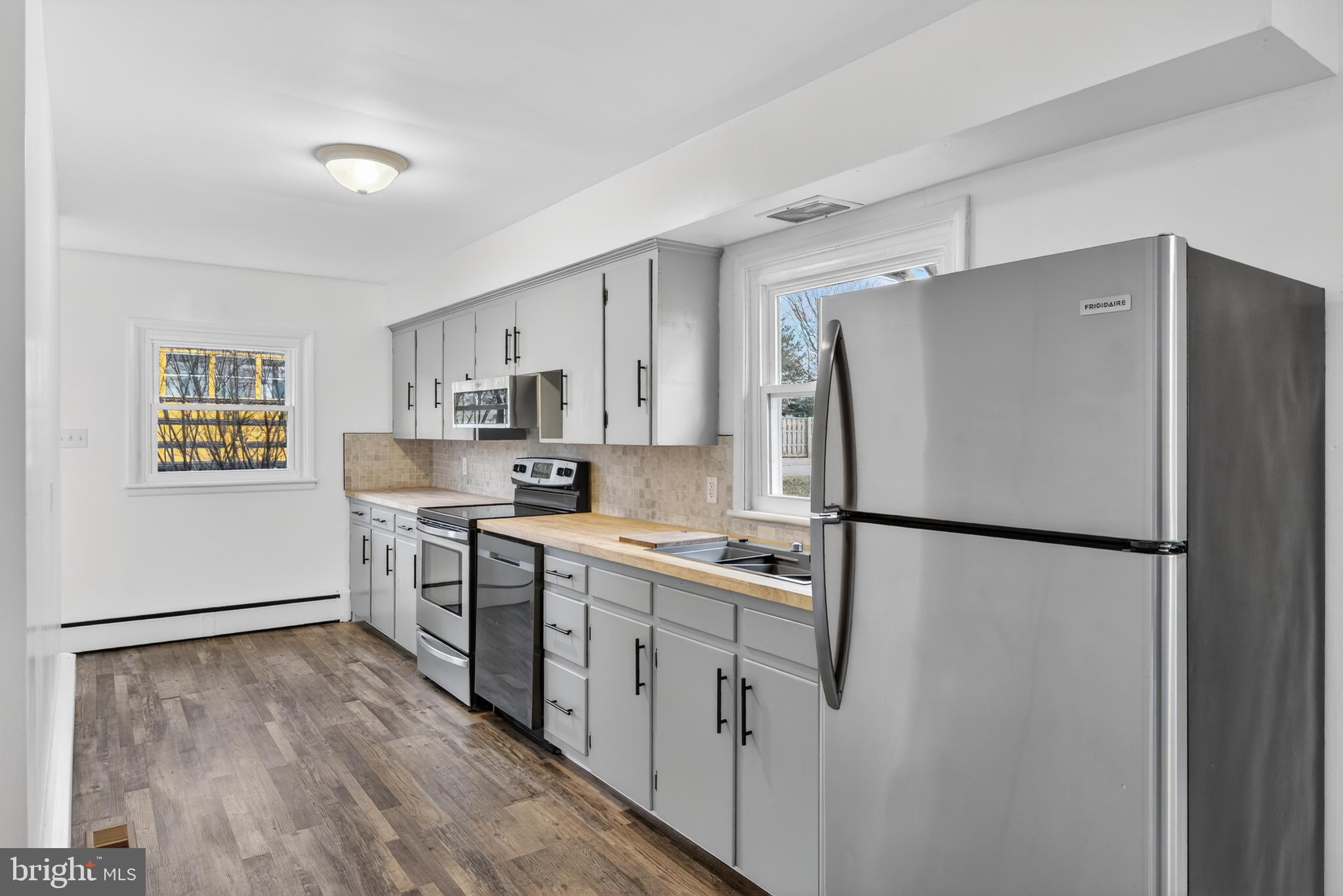 10 Dixie Drive Red Lion, PA 17356 - Photo 10 of 32 a kitchen with stainless steel appliances a refrigerator a sink a stove a microwave and white cabinets