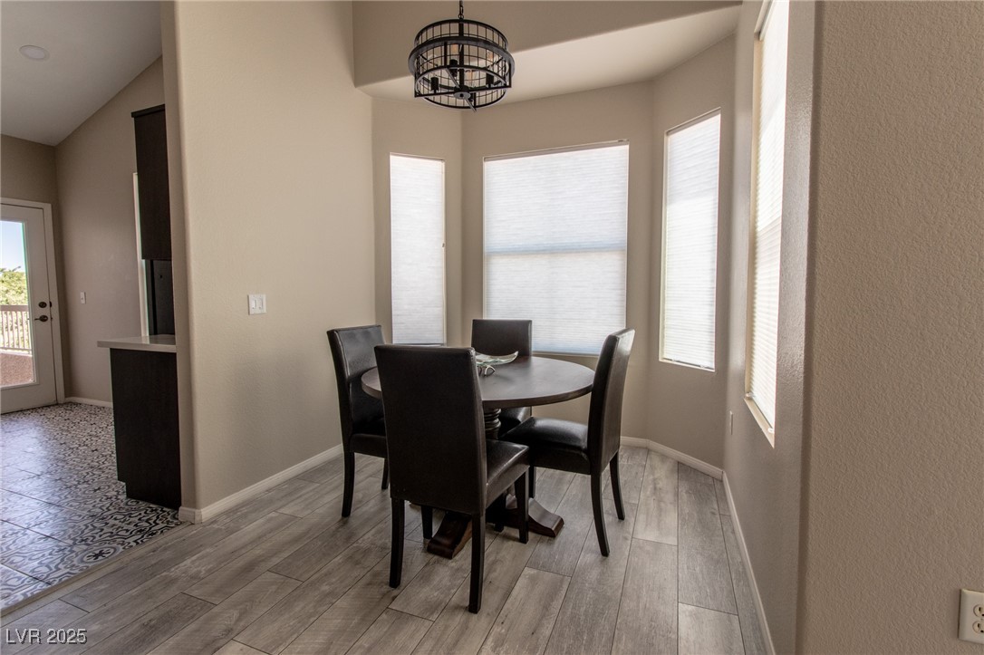 10550 West Alexander Road, Unit 2068 Las Vegas, NV 89129 - Photo 10 of 47 Dining room featuring light wood-style floors and a chandelier