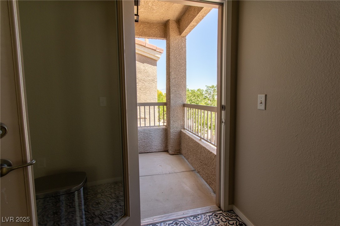 10550 West Alexander Road, Unit 2068 Las Vegas, NV 89129 - Photo 12 of 47 Entryway with a textured wall and tile patterned flooring