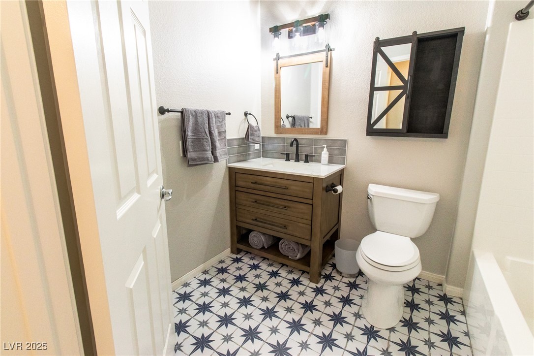 10550 West Alexander Road, Unit 2068 Las Vegas, NV 89129 - Photo 14 of 47 Full bathroom featuring vanity, bathing tub / shower combination, and a textured wall