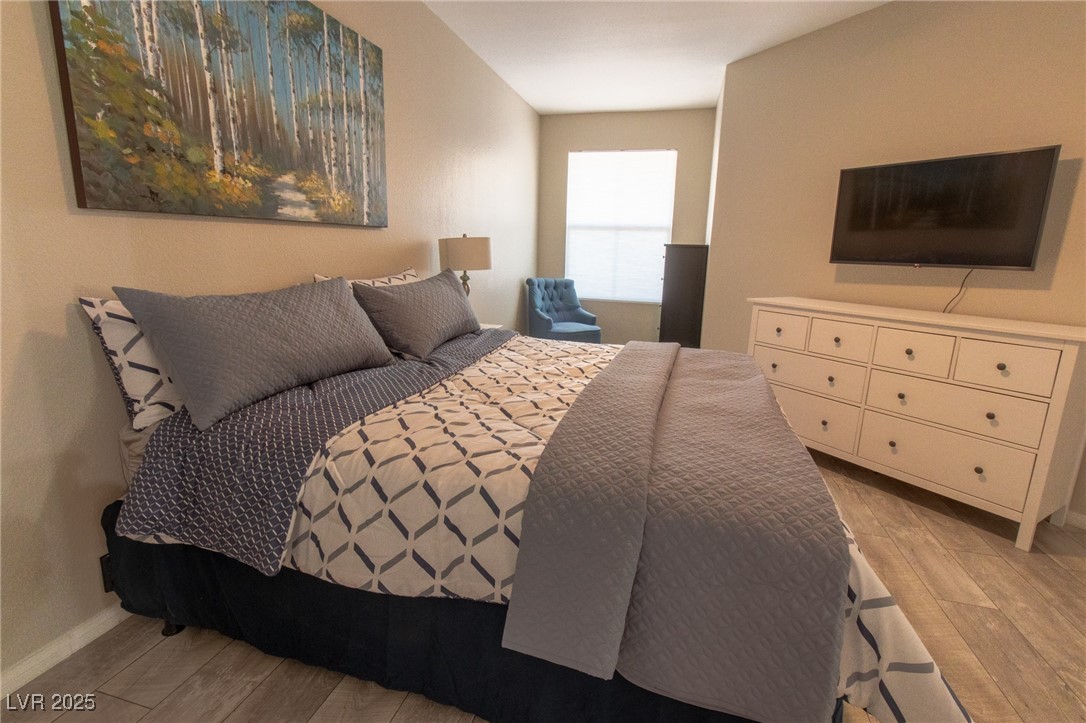 10550 West Alexander Road, Unit 2068 Las Vegas, NV 89129 - Photo 15 of 47 Bedroom with light wood-style flooring and baseboards