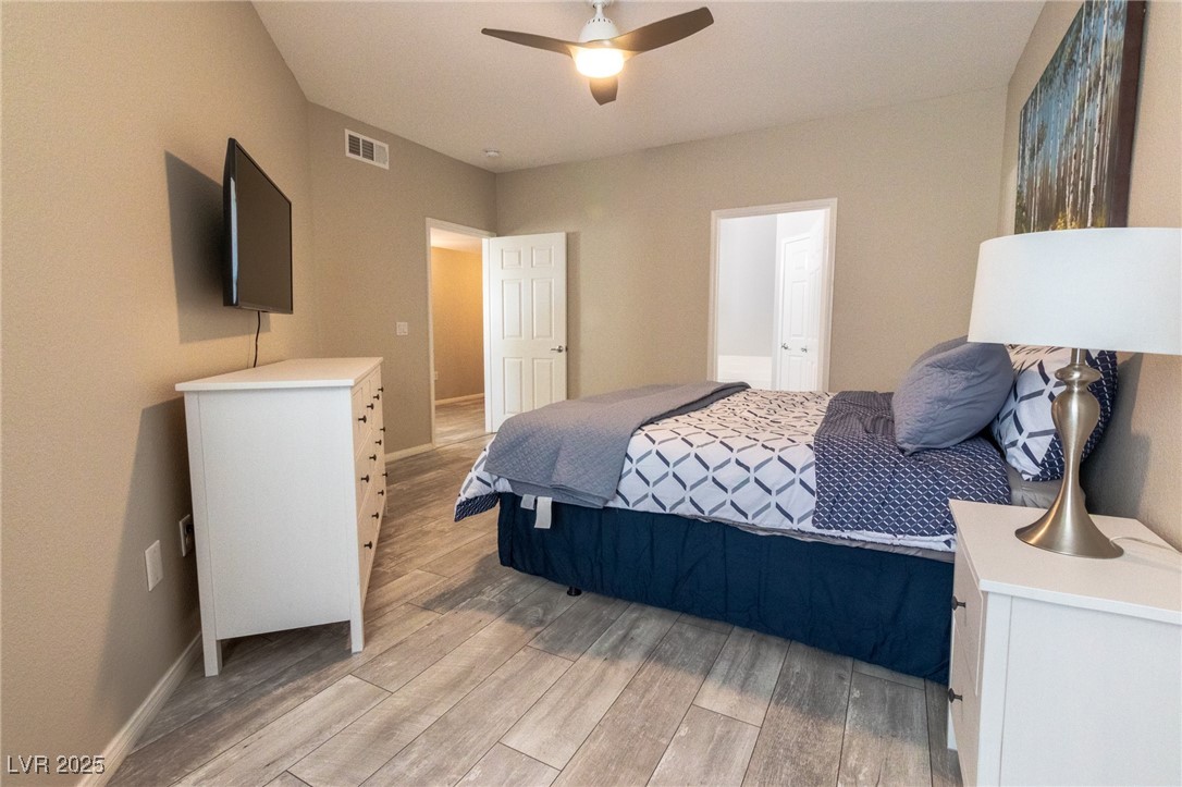 10550 West Alexander Road, Unit 2068 Las Vegas, NV 89129 - Photo 17 of 47 Bedroom with light wood-style flooring and a ceiling fan