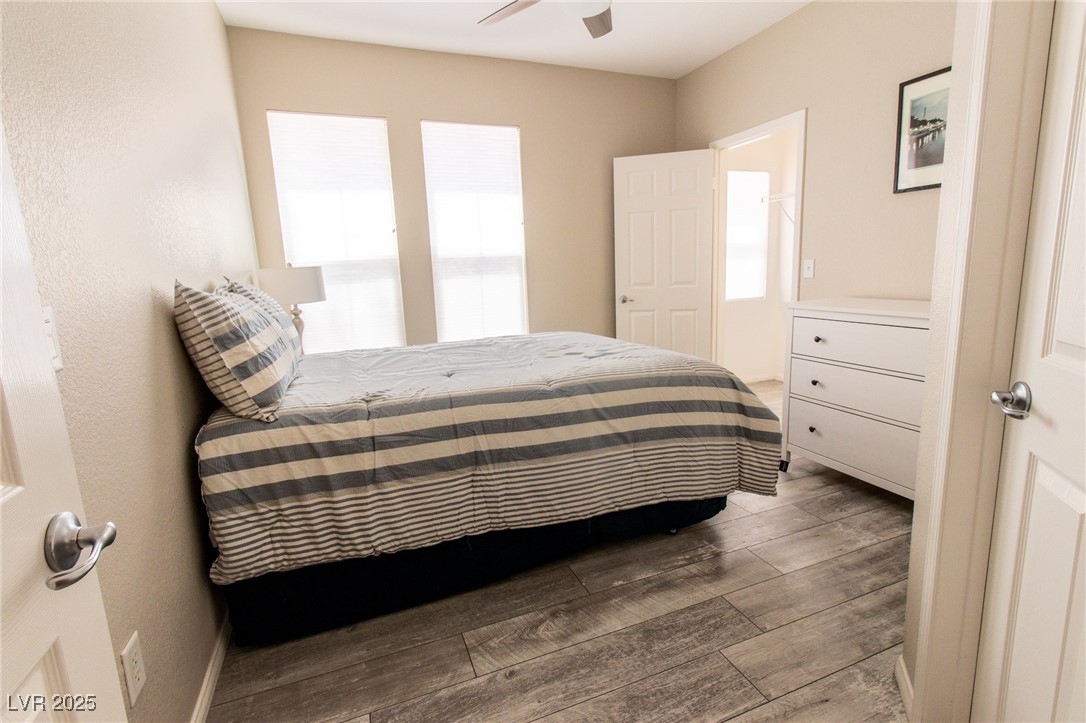 10550 West Alexander Road, Unit 2068 Las Vegas, NV 89129 - Photo 22 of 47 Bedroom with wood finished floors, a ceiling fan, and a textured wall