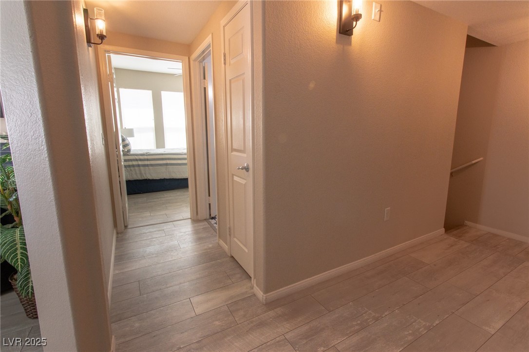 10550 West Alexander Road, Unit 2068 Las Vegas, NV 89129 - Photo 23 of 47 Hallway with light wood finished floors and baseboards