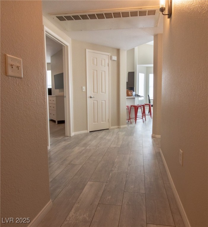 10550 West Alexander Road, Unit 2068 Las Vegas, NV 89129 - Photo 24 of 47 Hallway featuring a textured wall and light wood-style flooring