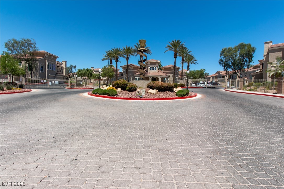 10550 West Alexander Road, Unit 2068 Las Vegas, NV 89129 - Photo 28 of 47 View of road with curbs, a gated entry, a residential view, and a gate