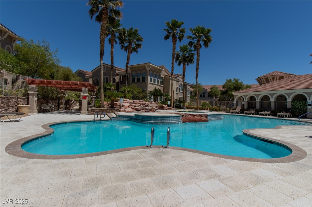 10550 West Alexander Road, Unit 2068 Las Vegas, NV 89129 - Photo 3 of 47 View of pool featuring a patio, a pergola, and a pool with connected hot tub