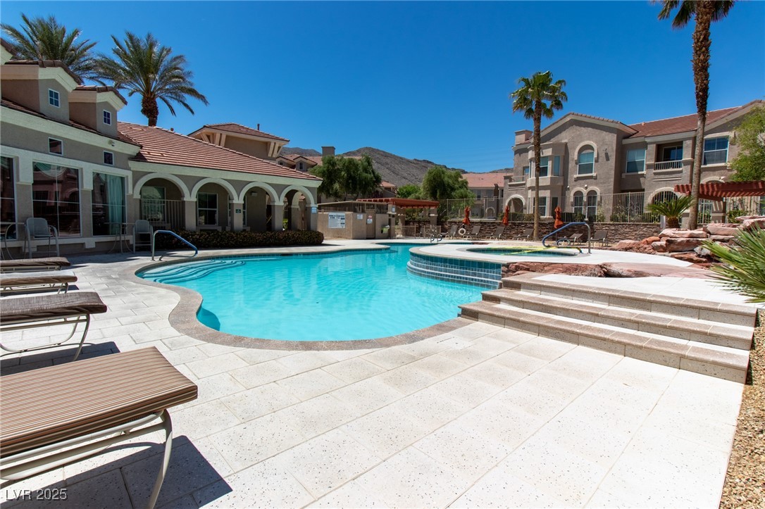 10550 West Alexander Road, Unit 2068 Las Vegas, NV 89129 - Photo 42 of 47 Community pool with a patio, a hot tub, and a mountain view