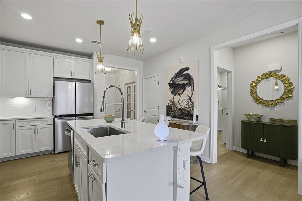 2 Codman Way, Unit 2203 Westborough, MA 01581 - Photo 8 of 36 a kitchen with a sink refrigerator and cabinets