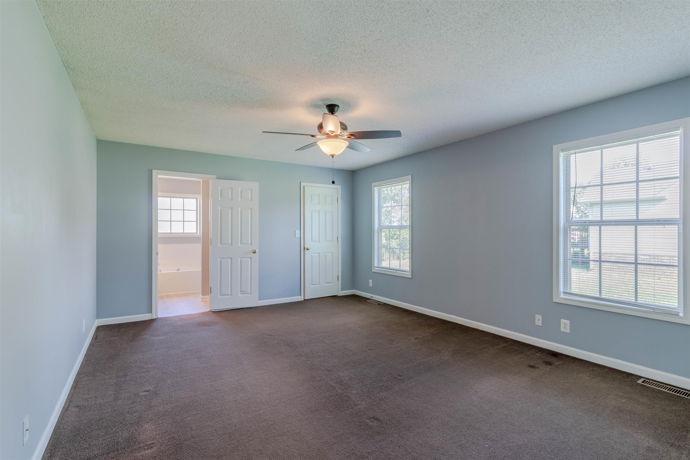1923 Needmore Road Clarksville, TN 37042 - Photo 12 of 28 Very large master bedroom with ceiling fan, new carpet, fresh paint, walk in closet, and full bathroom.