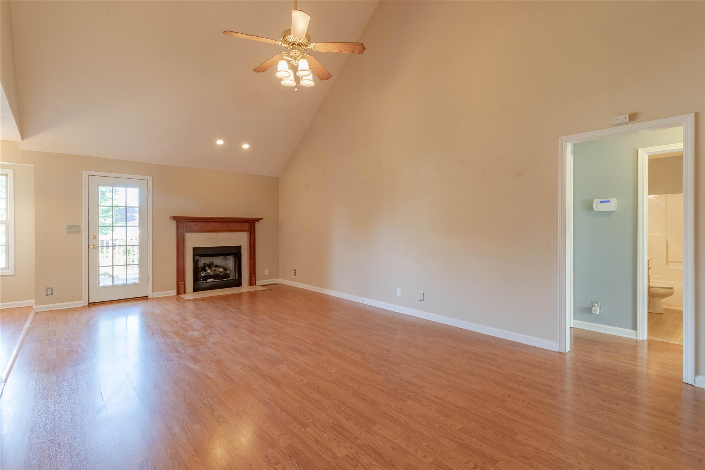 1923 Needmore Road Clarksville, TN 37042 - Photo 5 of 28 Another angle of the living room with beautiful high ceilings, nice laminate wood flooring, and ceiling fan