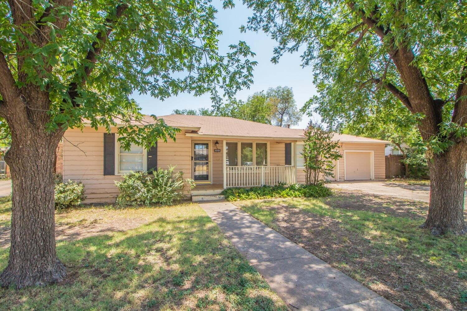 3813 35th Street Lubbock, TX 79413 - Photo 1 of 18 a front view of a house with a yard