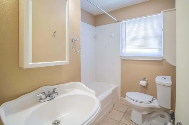 a bathroom with a sink a toilet and a bathtub
