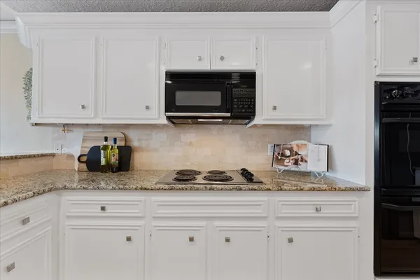 a kitchen with stainless steel appliances a refrigerator sink and cabinets