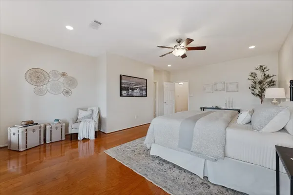 a bedroom with a large bed and a window