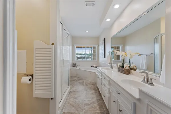 a bathroom with a bathtub and a window