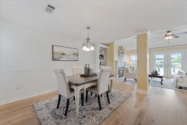 a view of a a dining room with furniture window and wooden floor