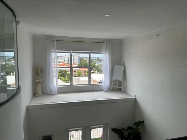 a bedroom with a bed and glass window