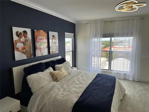 a bedroom with a bed and a large window