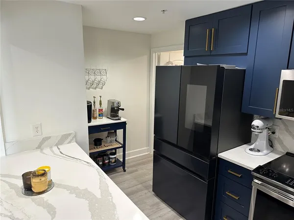 a kitchen with stainless steel appliances a refrigerator and a stove