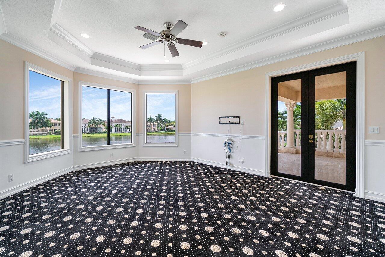 9636 Bridgebrook Drive Boca Raton, FL 33496 - Photo 19 of 50 a bedroom with large window and a chandelier
