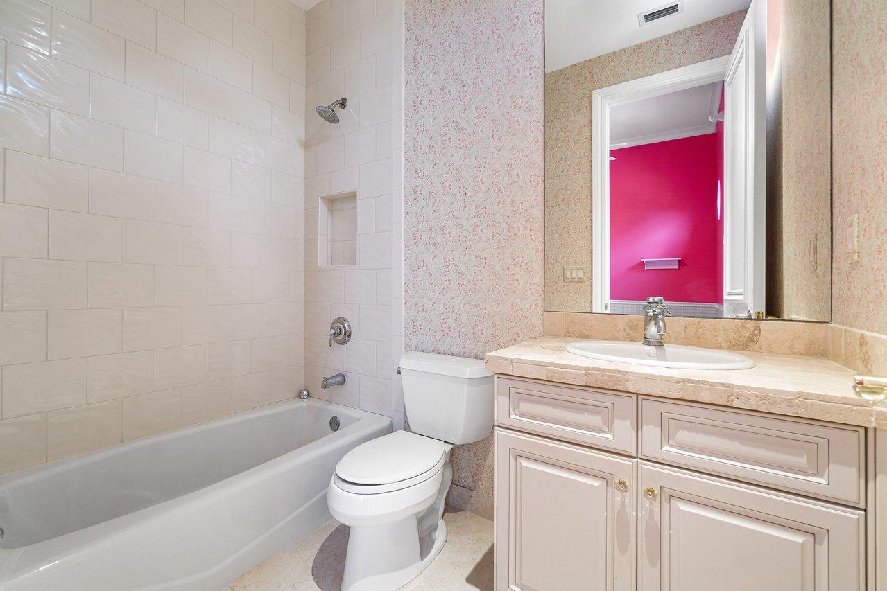 9636 Bridgebrook Drive Boca Raton, FL 33496 - Photo 30 of 50 a bathroom with a granite countertop toilet a sink and a bathtub