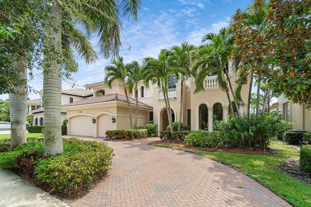 9636 Bridgebrook Drive Boca Raton, FL 33496 - Photo 3 of 50 a front view of a house with a garden