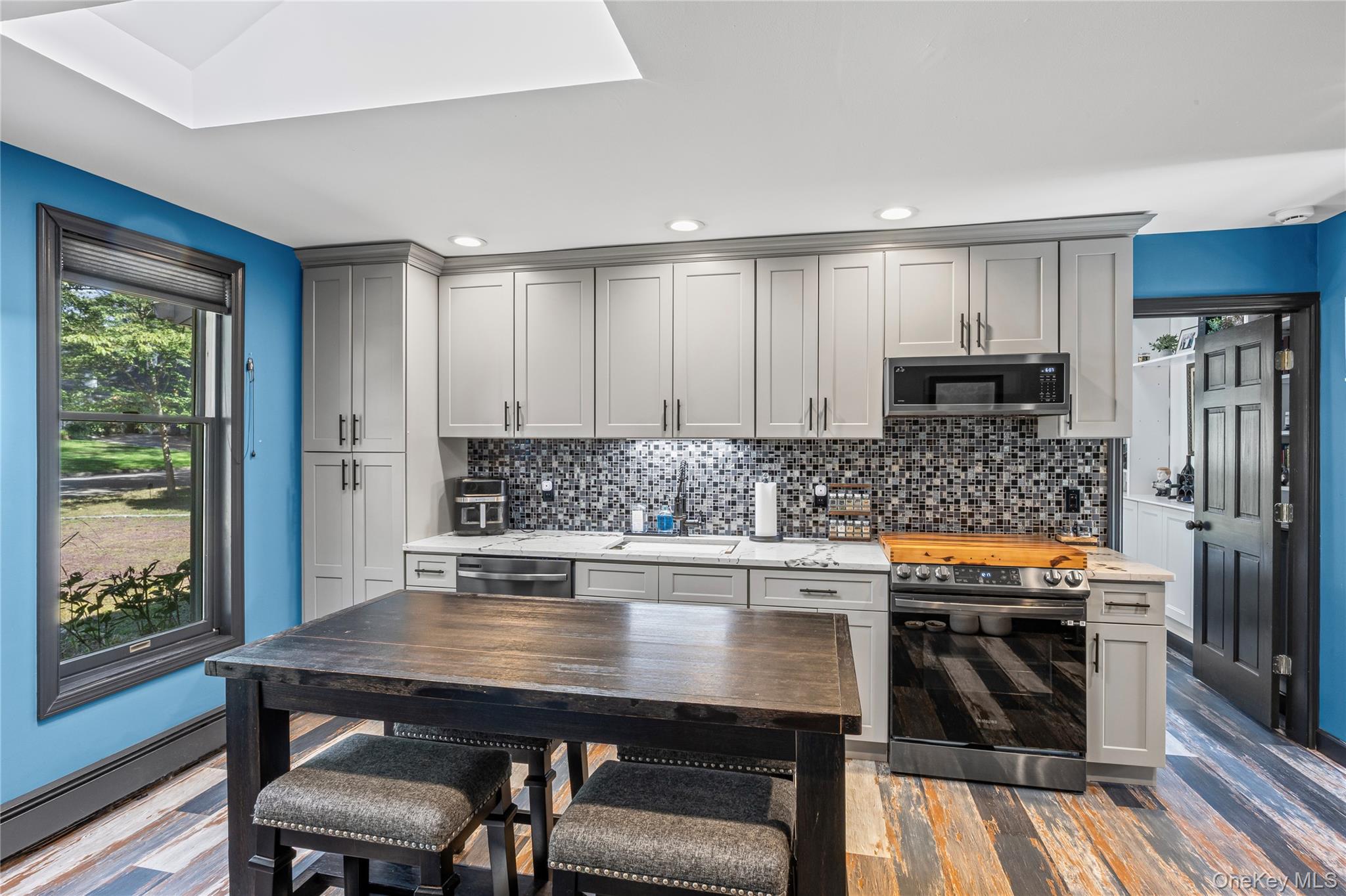 4 Model Court Rocky Point, NY 11778 - Photo 11 of 36 a kitchen with granite countertop a refrigerator stove and sink